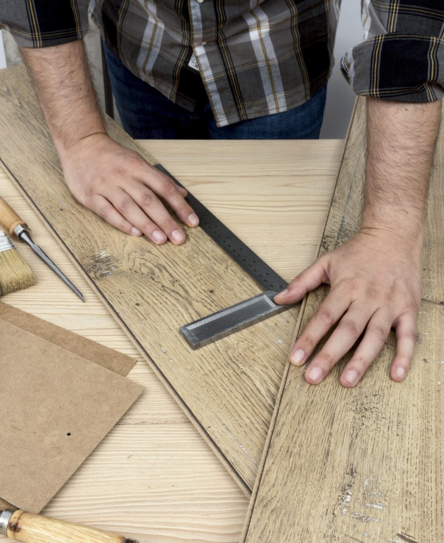 high-view-holding-wood-planks-carpentry-workshop-concept